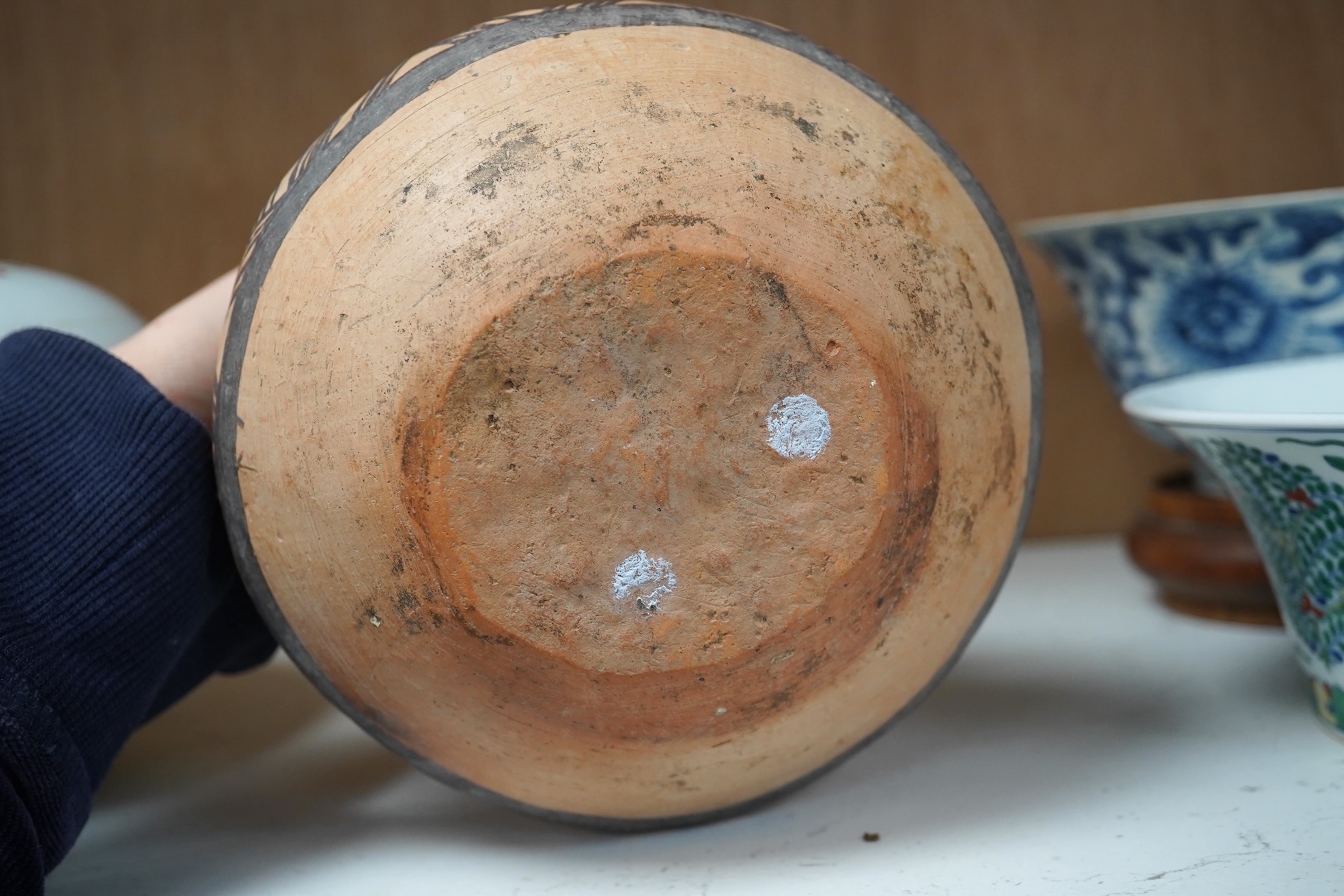 A Chinese neolithic pottery two handled jar - 14cm tall. Condition - fair to good, Provenance: the vendor‘s parents lived in Hong Kong from 1947 and bought the jar from a specialist dealer before 1980.